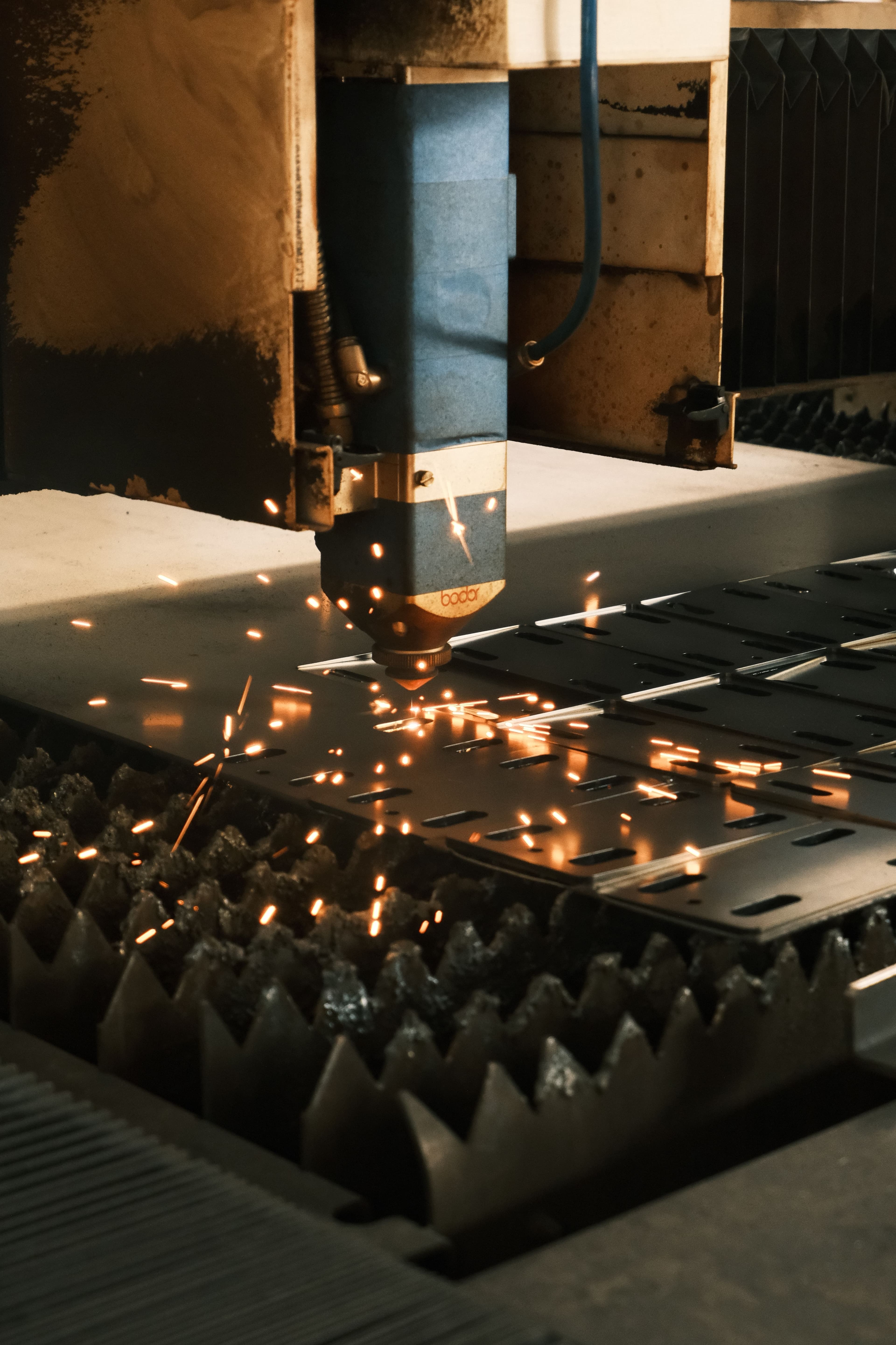 Laser cutting machine cutting steel sheet with sparks
