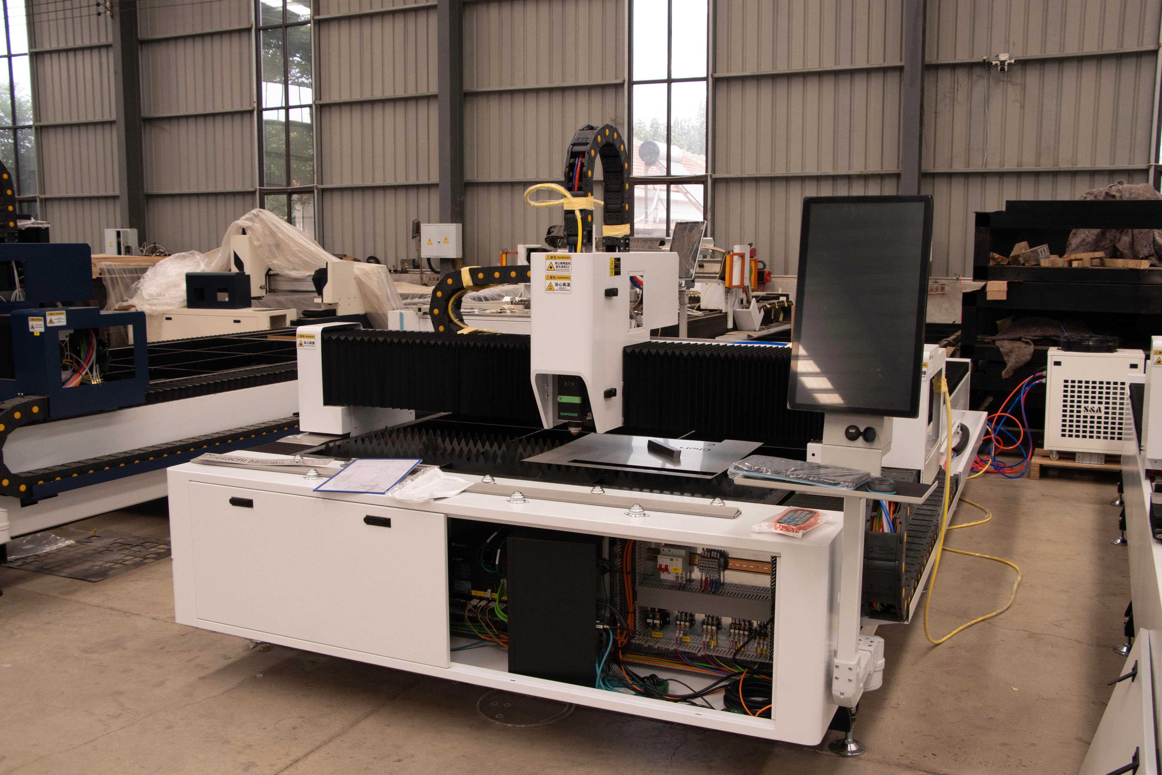 Industrial laser cutting machine in a factory setting