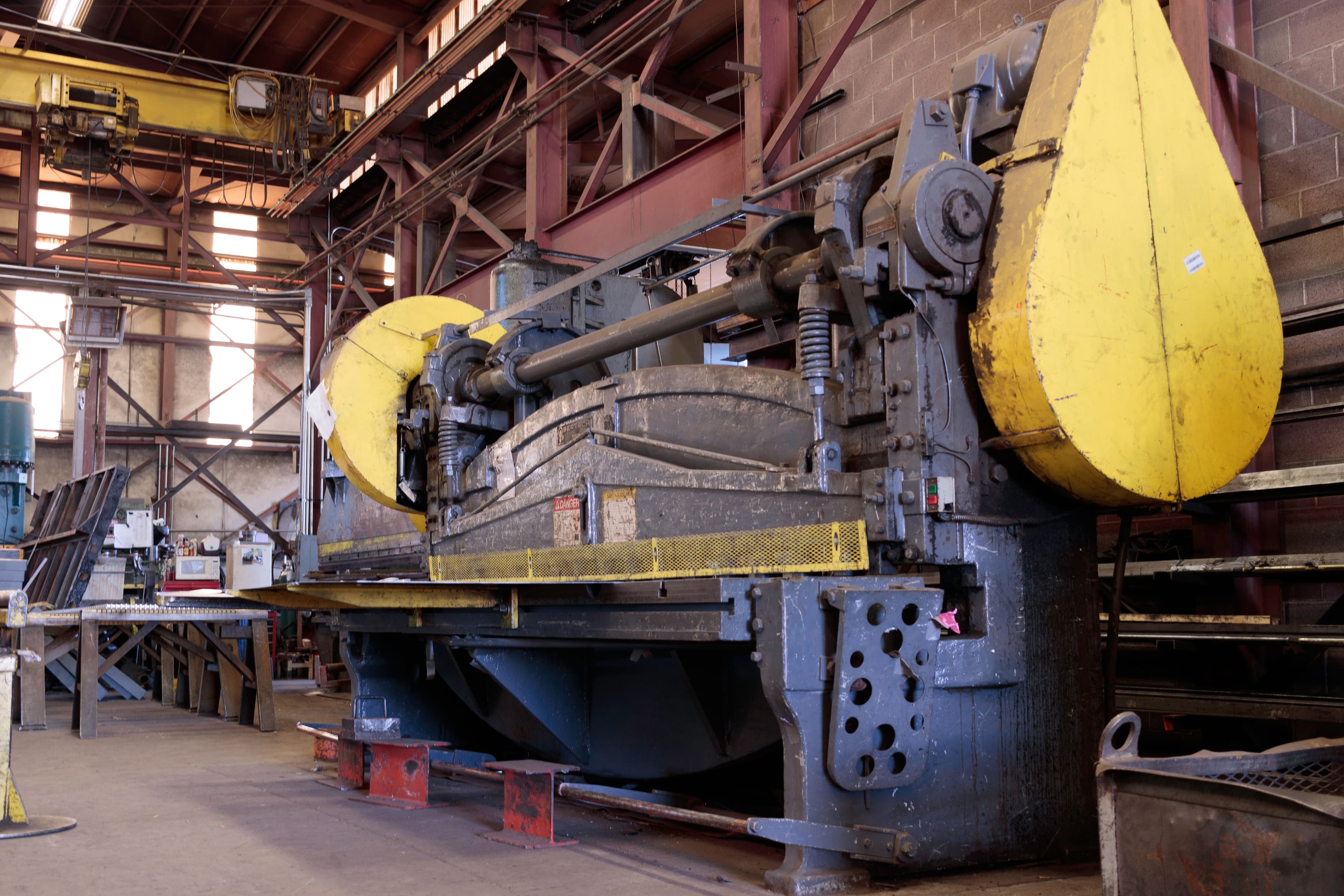 Heavy-duty industrial shearing machine in a factory